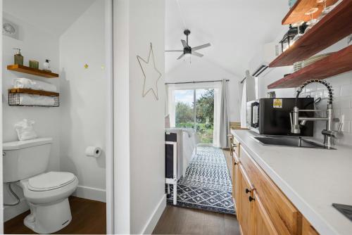a bathroom with a toilet and a sink and a sink at Twilight Ranch Tiny Homes - pet friendly & hill country views in Fredericksburg