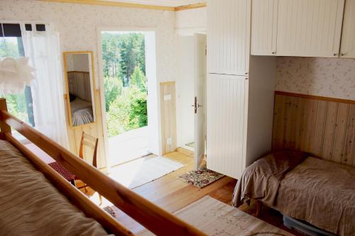 a bedroom with a bed and a large window at Lillstugan in Älvkarleby