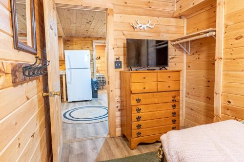 a bedroom with a refrigerator and a dresser at Northern Acres in Lake George