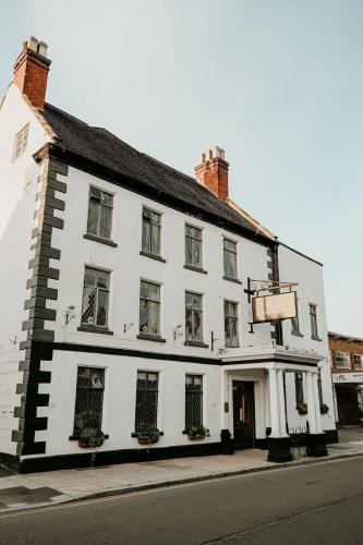 a white building on the side of a street at The Hart in Uttoxeter