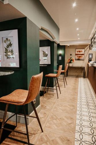 a waiting room with chairs and a table at The Hart in Uttoxeter