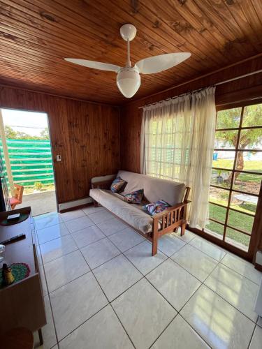 a living room with a couch and a ceiling fan at Rincón de Juanita in Rivera