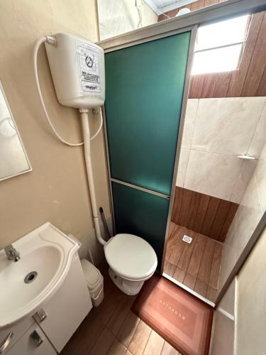 a small bathroom with a toilet and a sink at Rincón de Juanita in Rivera