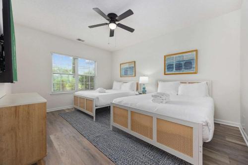 a bedroom with two beds and a ceiling fan at Myrtle Golf Escape At Legends-Pool-Pet Friendly in Myrtle Beach