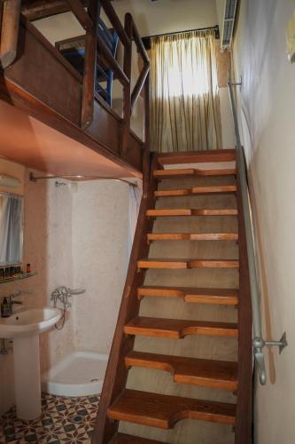 a staircase in a bathroom with a sink and a toilet at Traditional Villa with pool in Sfakia in Ímbros