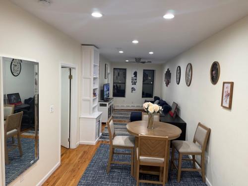 a dining room and living room with a table and chairs at Weehawken Apartment NYC Skyline in Weehawken