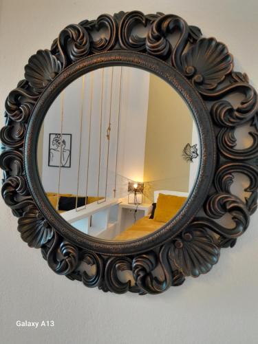 an ornate mirror hanging on a wall at Overhill Apartments Adamas in Adamantas