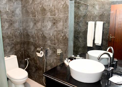 a bathroom with a toilet and a sink at Royalton Hotel Rawalpindi in Rawalpindi
