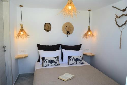 a bedroom with a bed with black and white pillows at Enalios House in Vourvoúlos