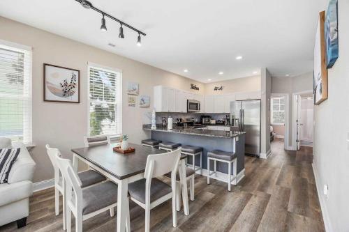 a kitchen and dining room with a table and chairs at Sunshine Derby - 1 Block to Beach- Garage EV Cha in Myrtle Beach