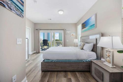 a bedroom with a bed and a table with a lamp at Sunshine Derby - 1 Block to Beach- Garage EV Cha in Myrtle Beach