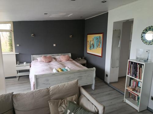 a bedroom with a bed and a couch at Le Coq de Champagne in Dormans