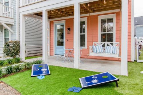 a house with two signs on the lawn at Happy Ours, Mins to Park Circle, Dtwn, CHS Beach in Charleston