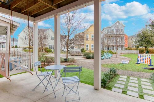 a patio with a table and chairs and a yard at Happy Ours, Mins to Park Circle, Dtwn, CHS Beach in Charleston