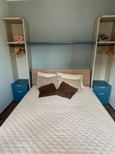 a bedroom with a white bed with two pillows at NessunConfine Casa Laura in Santa Giuletta
