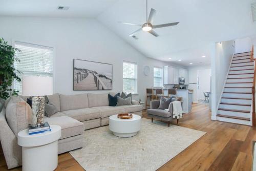 a living room with a couch and a ceiling fan at The Jade, Park Circle, Mins to Dwtn and Beaches in Charleston