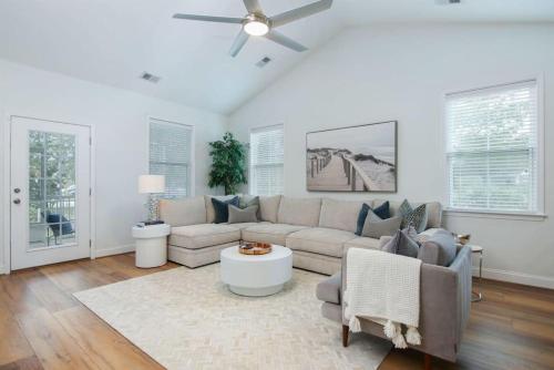 a living room with a couch and a ceiling fan at The Jade, Park Circle, Mins to Dwtn and Beaches in Charleston