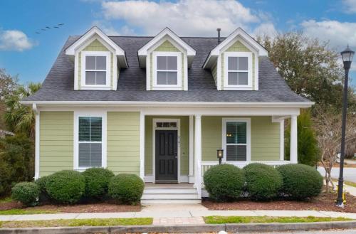 a green house with a black roof at The Jade, Park Circle, Mins to Dwtn and Beaches in Charleston