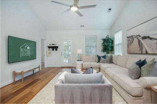 a living room with a couch and a ceiling fan at The Jade, Park Circle, Mins to Dwtn and Beaches in Charleston