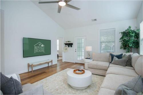 a living room with a couch and a table at The Jade, Park Circle, Mins to Dwtn and Beaches in Charleston