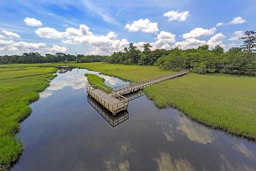 a river with a bridge in the middle of a field at Creekside Bungalow-Park Circle-15m dtwn CHS in Charleston