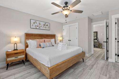 a bedroom with a bed and a ceiling fan at Creekside Bungalow-Park Circle-15m dtwn CHS in Charleston