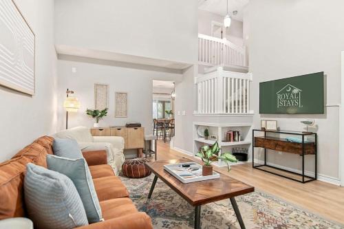 a living room with a couch and a table at Boho SoCo- 8 mins to Credit One, 20 mins to DTWN in Charleston