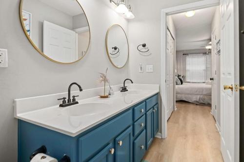a bathroom with a blue and white sink and a mirror at Boho SoCo- 8 mins to Credit One, 20 mins to DTWN in Charleston