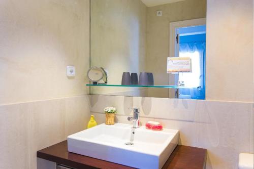 a bathroom with a white sink and a mirror at Anita's Bed and Breakfast in Barcelona
