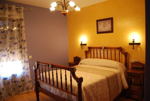 a bedroom with a bed and a window with a curtain at Casanavalon in El Peral