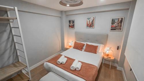 a small bedroom with a bed with two pillows at Tu Refugio en el Centro Histórico de Castro in Castro-Urdiales