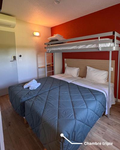 a bed in a room with a bunk bed at Premiere Classe Beaune in Beaune