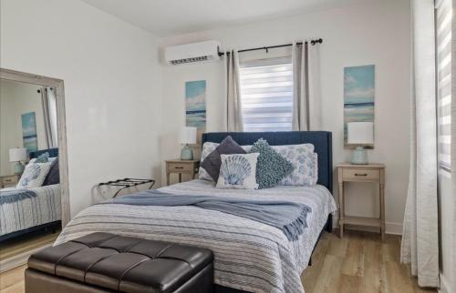 a bedroom with a bed with a blue comforter at La Casita St Pete in St. Petersburg
