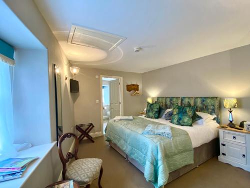 a bedroom with a large bed in a room at Kings Head - Riverside, Ravenstonedale in Ravenstonedale