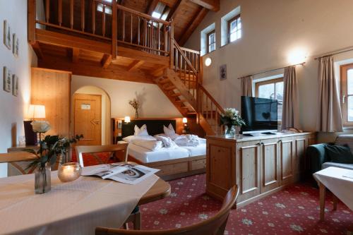 a hotel room with a bed and a staircase at Hotel Neuhäusl - herzlich familiär in Berchtesgaden