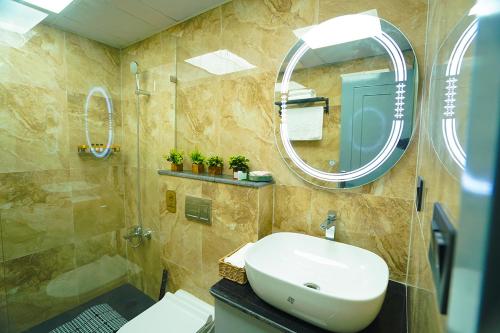 a bathroom with a sink and a mirror at Lux Lettings in Noida