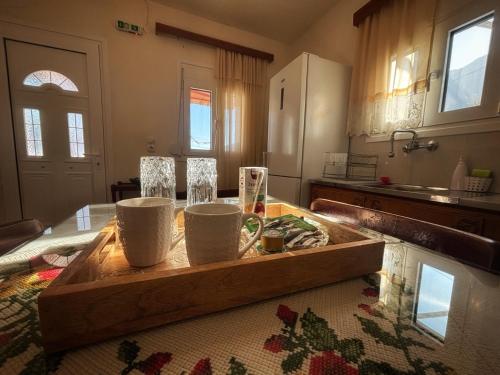 a kitchen with a wooden cutting board on a table at Georgaras Accommodation in Platanoússa