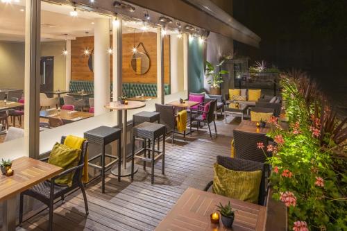 a restaurant with tables and chairs on a patio at Hilton Garden Inn Bristol City Centre in Bristol