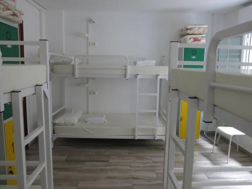 a room with two bunk beds in a room at A Barca de Pedra in Padrón