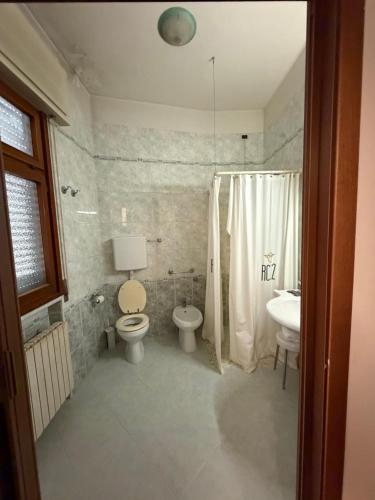 a bathroom with a toilet and a sink at UNITY BANK HOTEL Termale Padova RC12 in Abano Terme