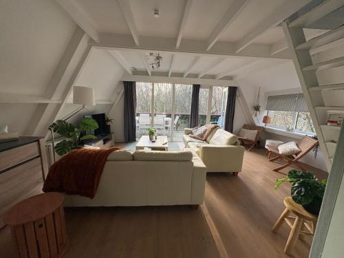 a living room with a couch and a table at Sequoia Duo 2 chalets voisins, familles,amis,détente in Durbuy
