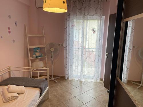 a small room with a bed and a window at Ioannis Apartment in Syvota