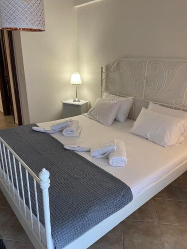 a bed with towels on top of it at Ioannis Apartment in Syvota
