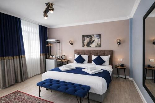 a bedroom with a large bed and a blue bench at Emirhan Inn Hotel, Sultanahmet in Istanbul