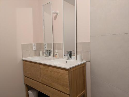 a bathroom with a sink and a mirror at Maison Terracotta in Saint-Priest-en-Jarez