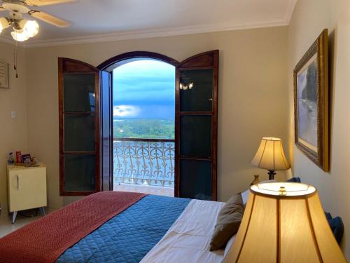 a bedroom with a bed and a large window at Restau de Marambaia in Barra de Guaratiba