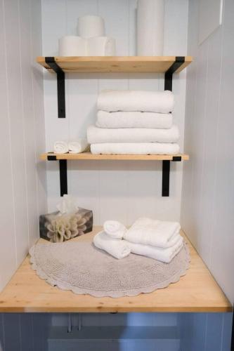 a bunch of towels are sitting on a shelf at Lilys Little Lodge in Blairmore