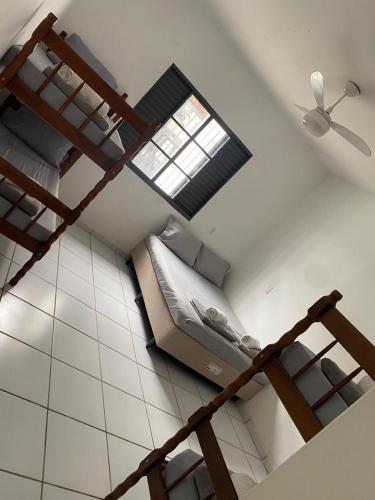 a bedroom with a bed and a ceiling fan at Espaço Guga in Sorocaba