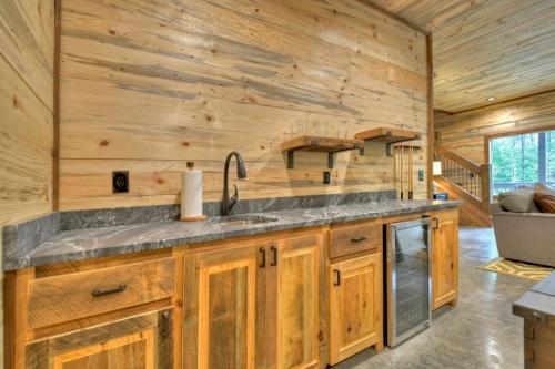 a kitchen with a sink in a wooden cabin at Altitude Adjustment- Luxury 3BR Cabin w/ Outdoor Living Area & Hot Tub in Epworth