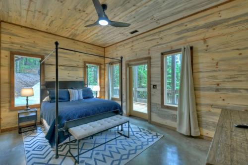 a bedroom with a bed in a log cabin at Altitude Adjustment- Luxury 3BR Cabin w/ Outdoor Living Area & Hot Tub in Epworth